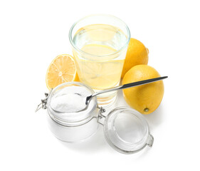 Glass of water, jar with baking soda and ripe lemons on white background