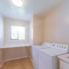 Square Sun flare Laundry room interior with vanity and stainless steel sink
