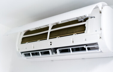 Air conditioner is hung on the wall. Open the front cover to wait for maintenance.