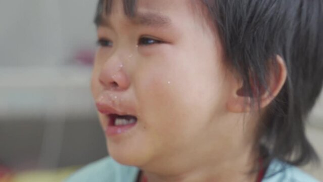 Baby boy was crying and calling his mother on the bed in the bedroom.