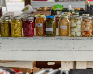 Flea marker canned collards, sauerkraut, jars of pickled cauliflower, pickled eggs.