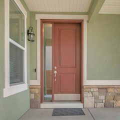Square Brown front door with sidelight at the entrance of a house