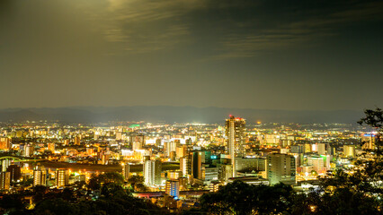 Fototapeta na wymiar 熊本市夜景風景「満月の都市景観・熊本駅周辺」(夜景観光名所)花岡山 Kumamoto City Night View 