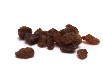 Closeup pile dried shriveled raisins white background