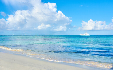 yacht on the beaches of cancun, turquoise ocean and a dramatic sky full of clouds.
