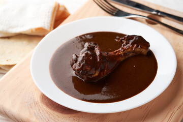 Chicken with mole, Mexican tradition, placed on wood