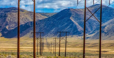 Long running powerlines into the mountains, across the desert