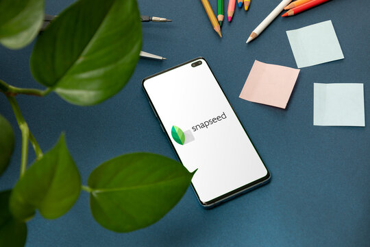 Mexico, CDMX - May 01, 2022: Cell phone with the snapseed logo on the screen on a blue background and graphic design stuff