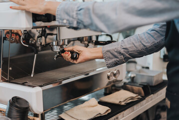 Close-up view on barista hands to making coffee with coffee machine. Coffee owner concept.