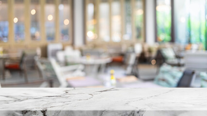 Obraz premium Empty white marble stone table top and blur glass window interior restaurant banner mock up abstract background - can used for display or montage your products.