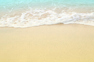 Fototapeta na wymiar Soft white blue sea wave on clean brown sandy beach coast have copyspace
