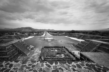 Tourists visit the ruins of the ancient city of Teotihuacán. Perspective view in black and white...