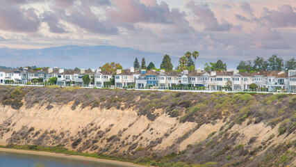 Panorama Puffy clouds at sunset Newport Beach neigborhood near the slope of the waterfront at Ca