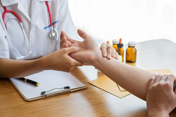 Image of a nurse checking a patient's pulse. A female doctor shakes hands giving her male patient...