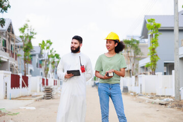 Arab man and team working. Professional woman and man. African American mixed-race people. Construction worker and business owner working on digital tablet computer in construction site