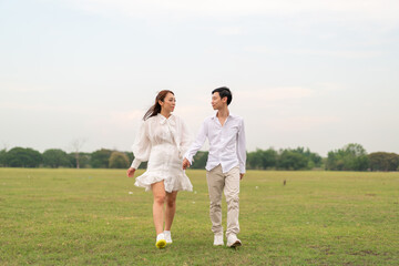 Happy young Asian couple in bride and groom clothing