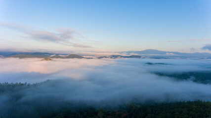Sun view over the clouds with mountains and mist Blue sky,