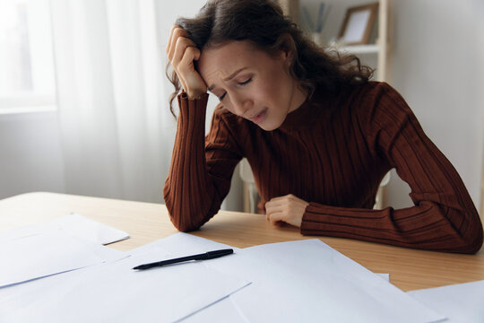 Upset unhappy suffering sad frustrated curly adorable woman doing facepalm touch forehead have serious financial problems bad relationships troubles at work worried about debt notification. Copy space