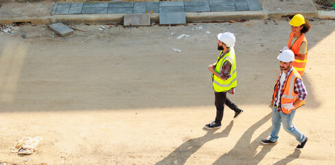 Top view walking. Group professional confident Mechanical civil Engineer and construction team at house project underconstruction site. Group portrait. Unity and teamwork concept.