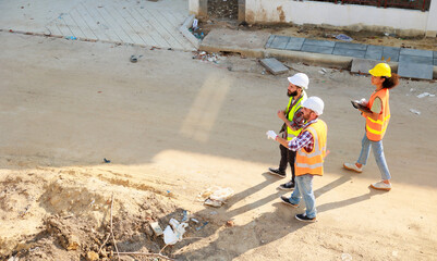 Top view walking. Group professional confident Mechanical civil Engineer and construction team at house project underconstruction site. Group portrait. Unity and teamwork concept.