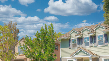 Panorama White puffy clouds Row of traditional houses at Ladera Ranch in Southern California