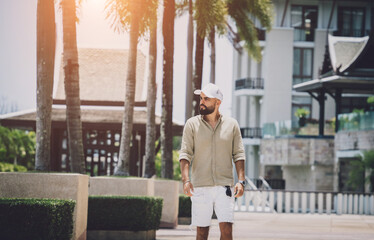 Portrait of a fashion young man posing at marina and yahts background