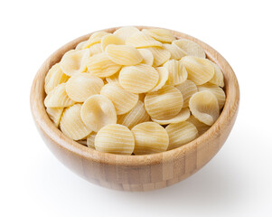 Uncooked orecchiette pasta in wooden bowl isolated on white background with clipping path