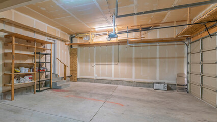 Panorama Large garage interior with wall filler white markings and shelves