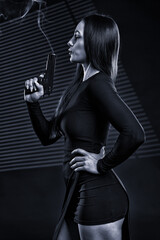 Fototapeta na wymiar Hitwoman with a gun, monochrome toned