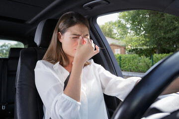 woman having headache while driving a car