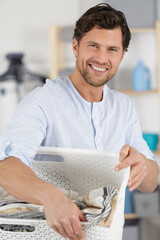 happy man holding a basket at home