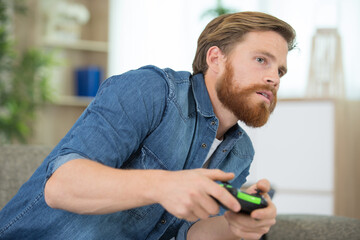 adult playing video game in the home