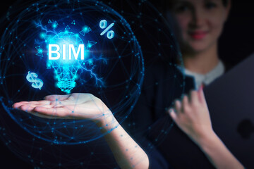 Business, Technology, Internet and network concept. Young businessman working on a virtual screen of the future and sees the inscription: BIM