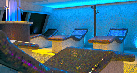 Relaxation room heated loungers with Balinese Asian decor inside spa wellness area thermal suite...