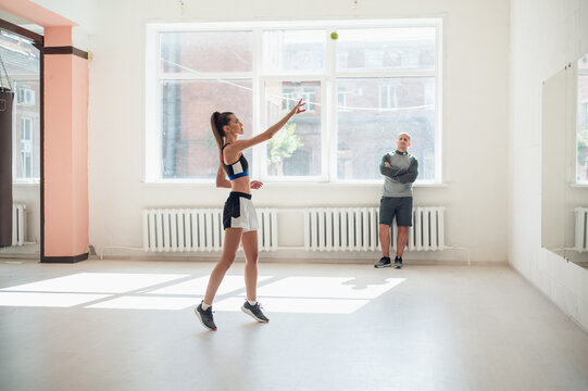 A Young Girl Performs A Coach's Task For Coordination And Quick Reaction Under The Guidance Of Her Coach