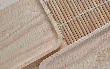 Background the wooden tray and bamboo cooking mat