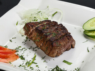 Grilled beef steak served onion