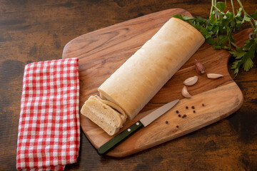 top view of a topped bread on a wooden board