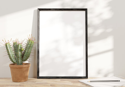 Black frame leaning on white shelve in bright interior with plants mockup 3D rendering