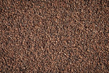 Brown cement plaster with small stones. Abstract background