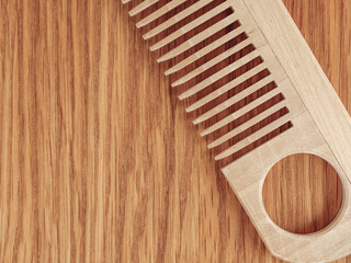 Brown hair comb on wooden background