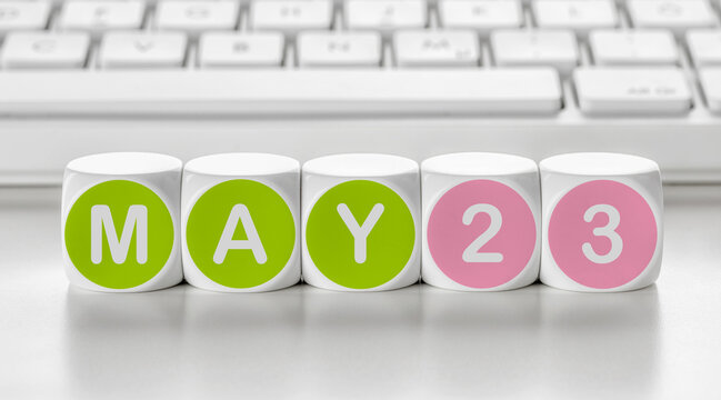 Letter dice in front of a keyboard - May 23