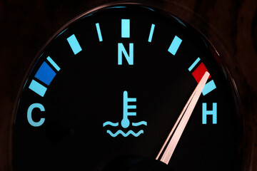 temperature gauge in car dashboard in illuminated night mode – hot