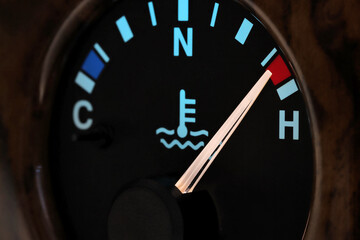temperature gauge in car dashboard in illuminated night mode – hot