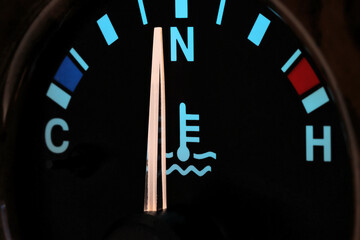 temperature gauge at normal operating temperature in car dashboard in illuminated night mode