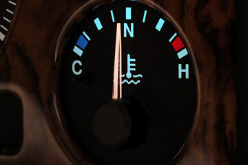 temperature gauge at normal operating temperature in car dashboard in illuminated night mode