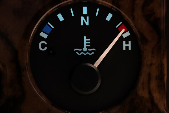 temperature gauge in car dashboard in illuminated night mode – hot