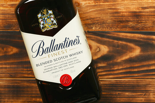 A bottle of Ballantines blended Scotch whisky on wooden background with copy space