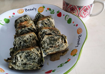 egg roll with spinach and coffee cup
