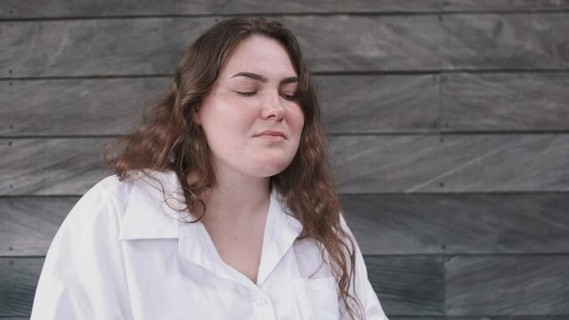 Close-up of overweight caucasian female upset and depressed, breathing heavily and ready to cry